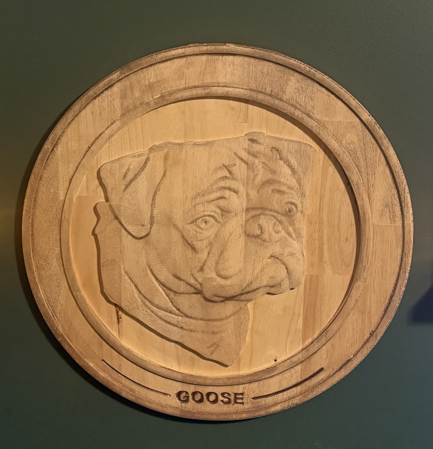 Dimensional pug portrait carved in wood